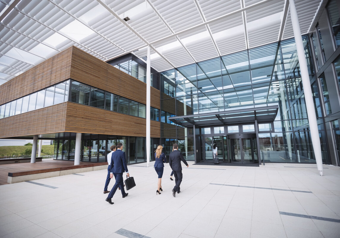 Group of business people entering into an office building